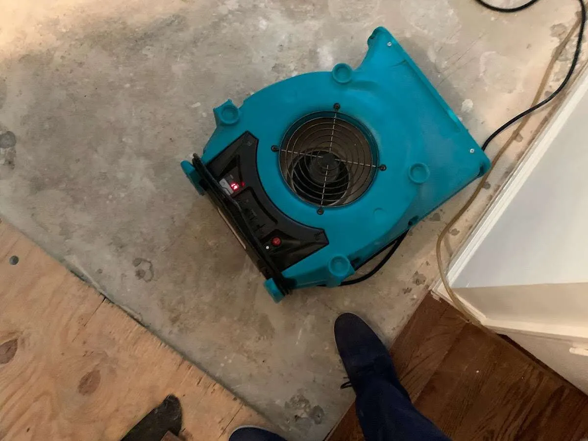 Air mover drying subfloor during Commercial Water Damage Restoration in White Hall